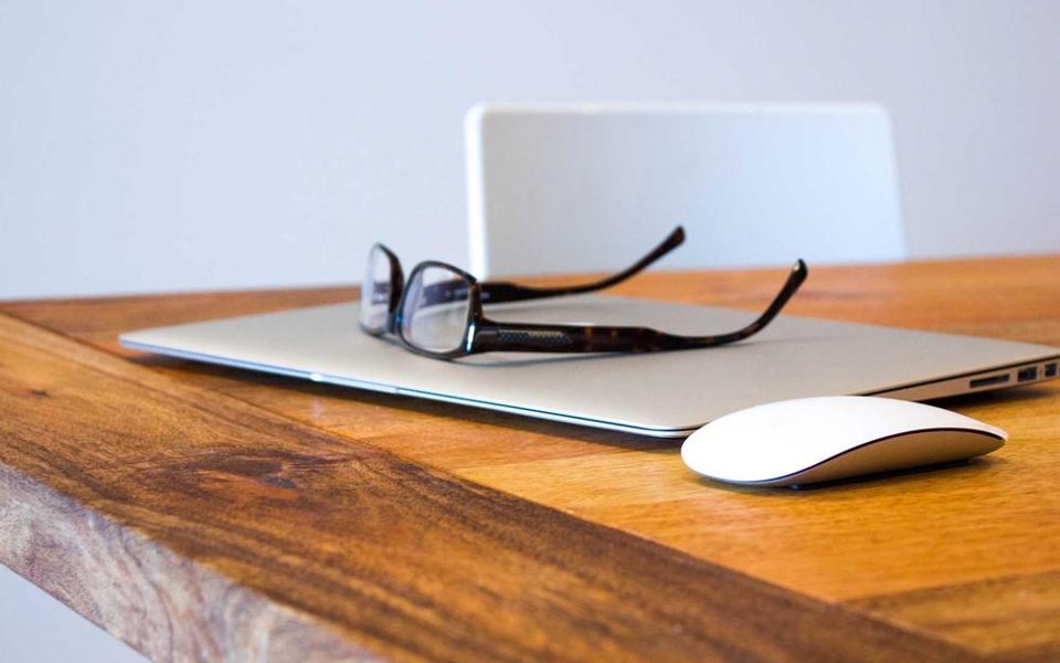 Handwritten notes next to a pair of spectacles