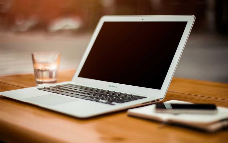 A neat desk with a laptop left open